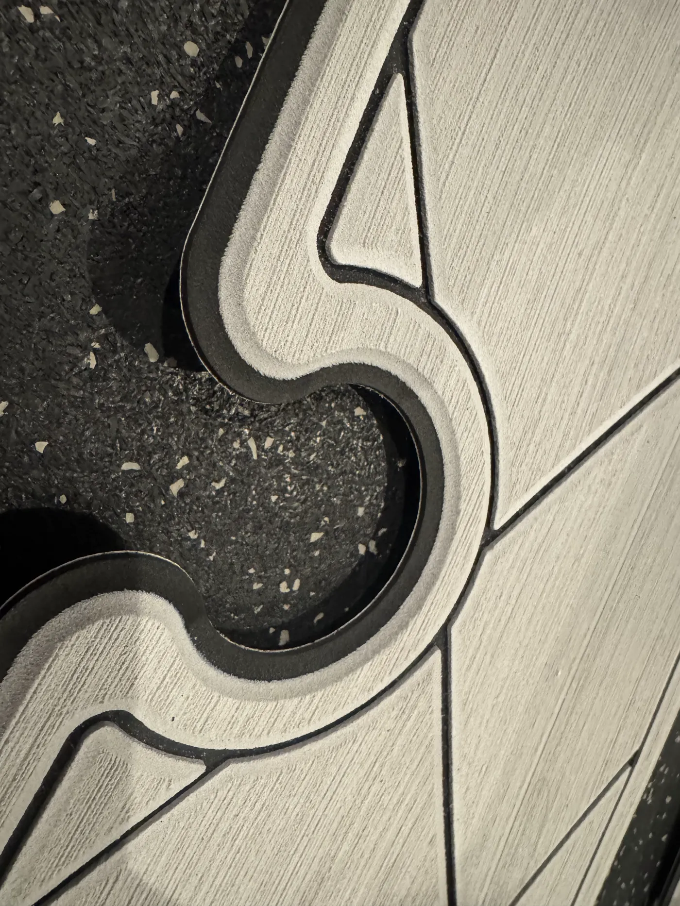 Close-up of routed foam panels showing the surface texture, dark base layer and cut edges